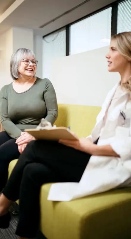 Healthcare professionals discussing patient care in a comfortable setting